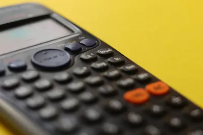 Logo designer calculating rate on a calculator